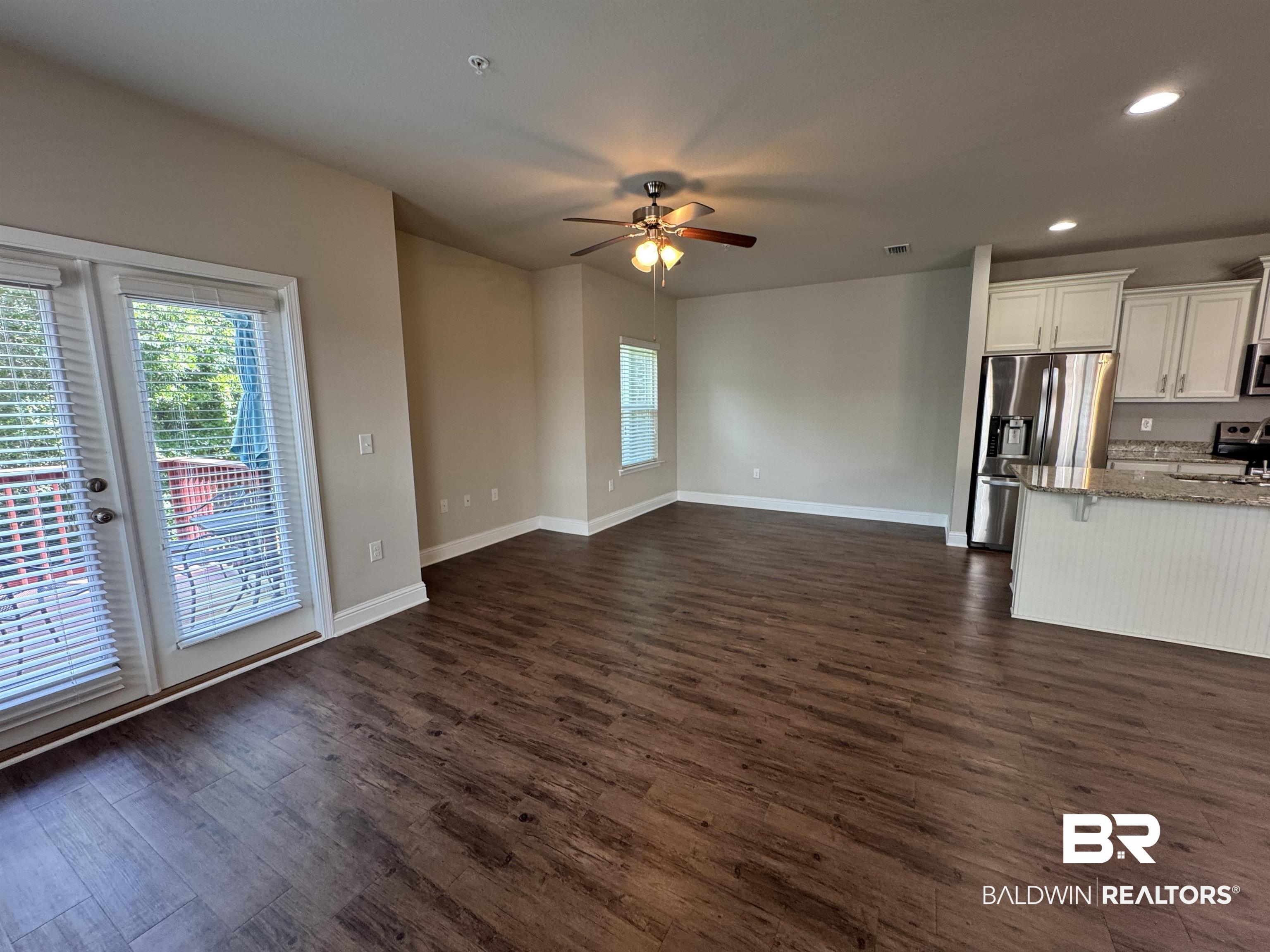 6811 Spaniel Drive, Unit C Daphne, AL 36527 - Photo 11 of 33 Unfurnished living room with ceiling fan, dark wood-style floors, recessed lighting, and baseboards
