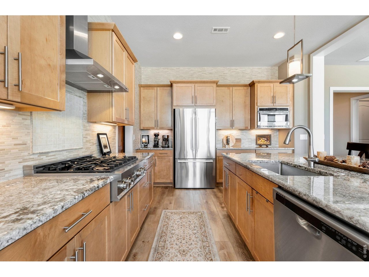 1030 Larimer Ridge Parkway Timnath, CO 80547 - Photo 11 of 38 a kitchen with stainless steel appliances granite countertop a sink stove and refrigerator