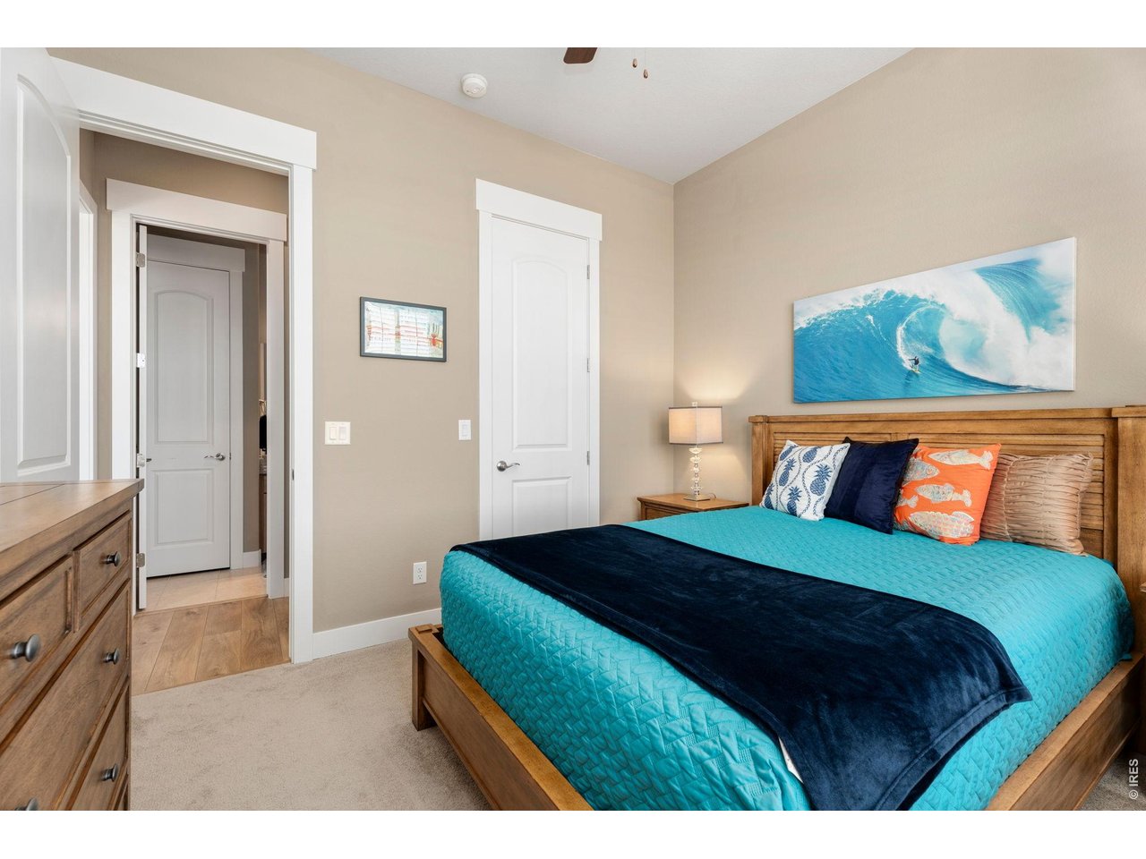 1030 Larimer Ridge Parkway Timnath, CO 80547 - Photo 17 of 38 a bedroom with a bed and a painting on the wall