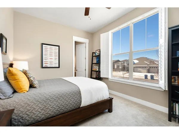 a bedroom with a bed and a painting on the wall