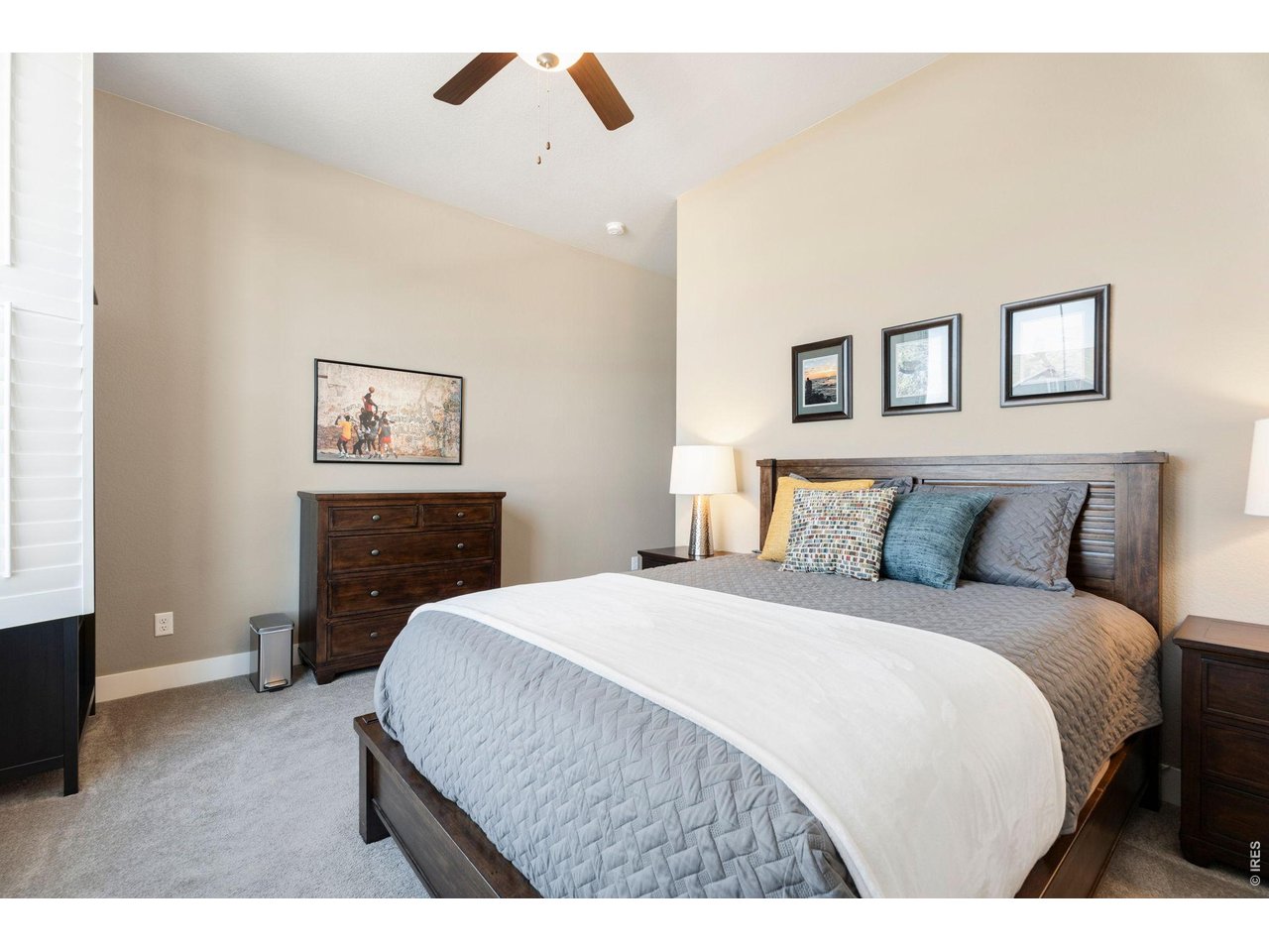 1030 Larimer Ridge Parkway Timnath, CO 80547 - Photo 23 of 38 a bedroom with a bed and a painting on the wall