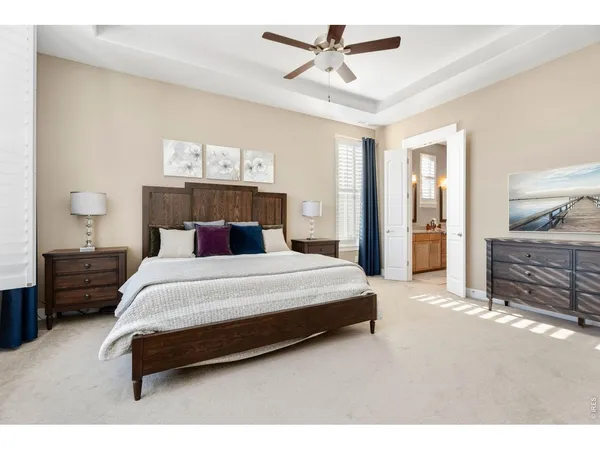 a bedroom with a bed a couch and a window