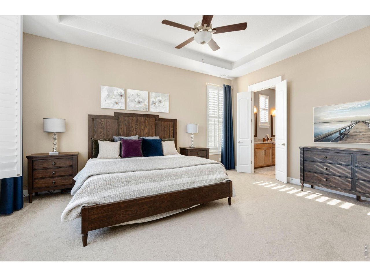 1030 Larimer Ridge Parkway Timnath, CO 80547 - Photo 25 of 38 a bedroom with a bed a dresser and flowerpot