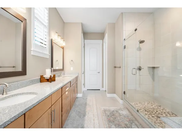 a bathroom with a double vanity sink and mirror