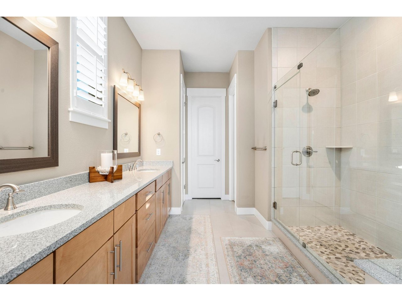 1030 Larimer Ridge Parkway Timnath, CO 80547 - Photo 28 of 38 a bathroom with a granite countertop sink a mirror a shower and a bathtub