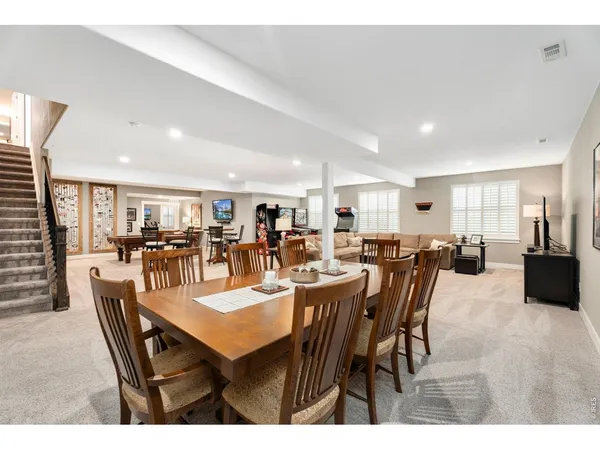 a living room with furniture a flat screen tv and a window