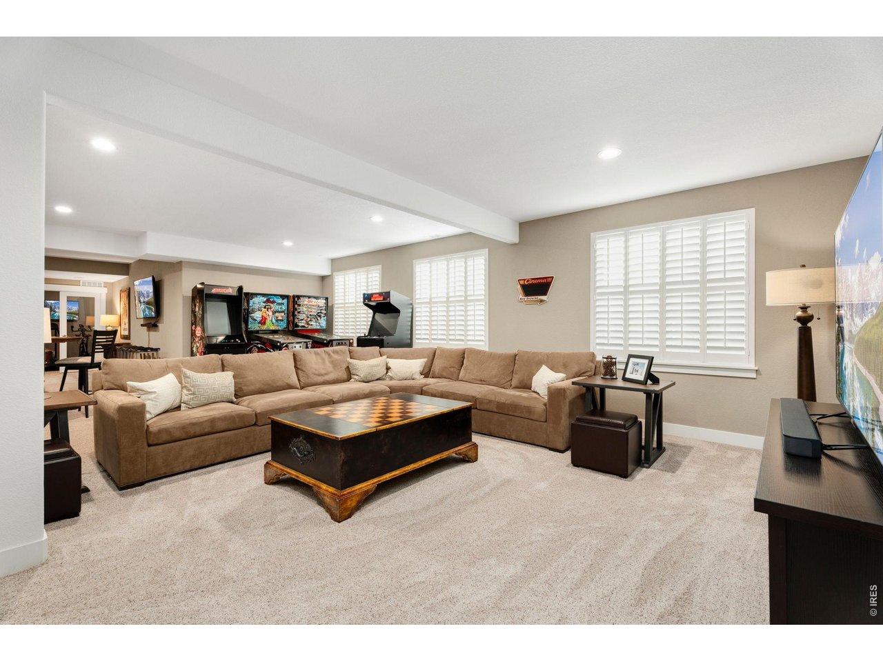 1030 Larimer Ridge Parkway Timnath, CO 80547 - Photo 31 of 38 a living room with furniture a flat screen tv and a window