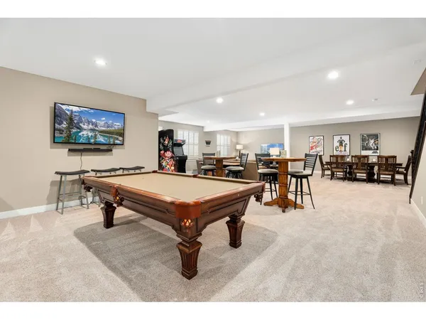 a room with furniture pool table and windows