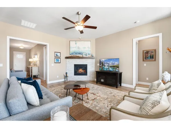 a living room with furniture and kitchen view