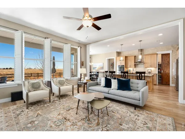 a living room with furniture kitchen view and a fireplace