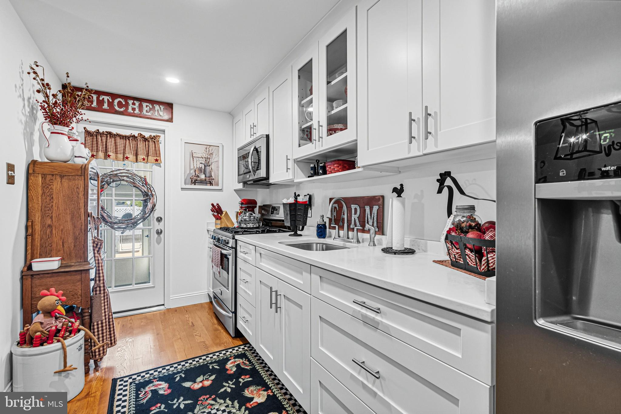 7815 Rockbourne Road Baltimore, MD 21222 - Photo 14 of 39 a kitchen with stainless steel appliances cabinets and a window