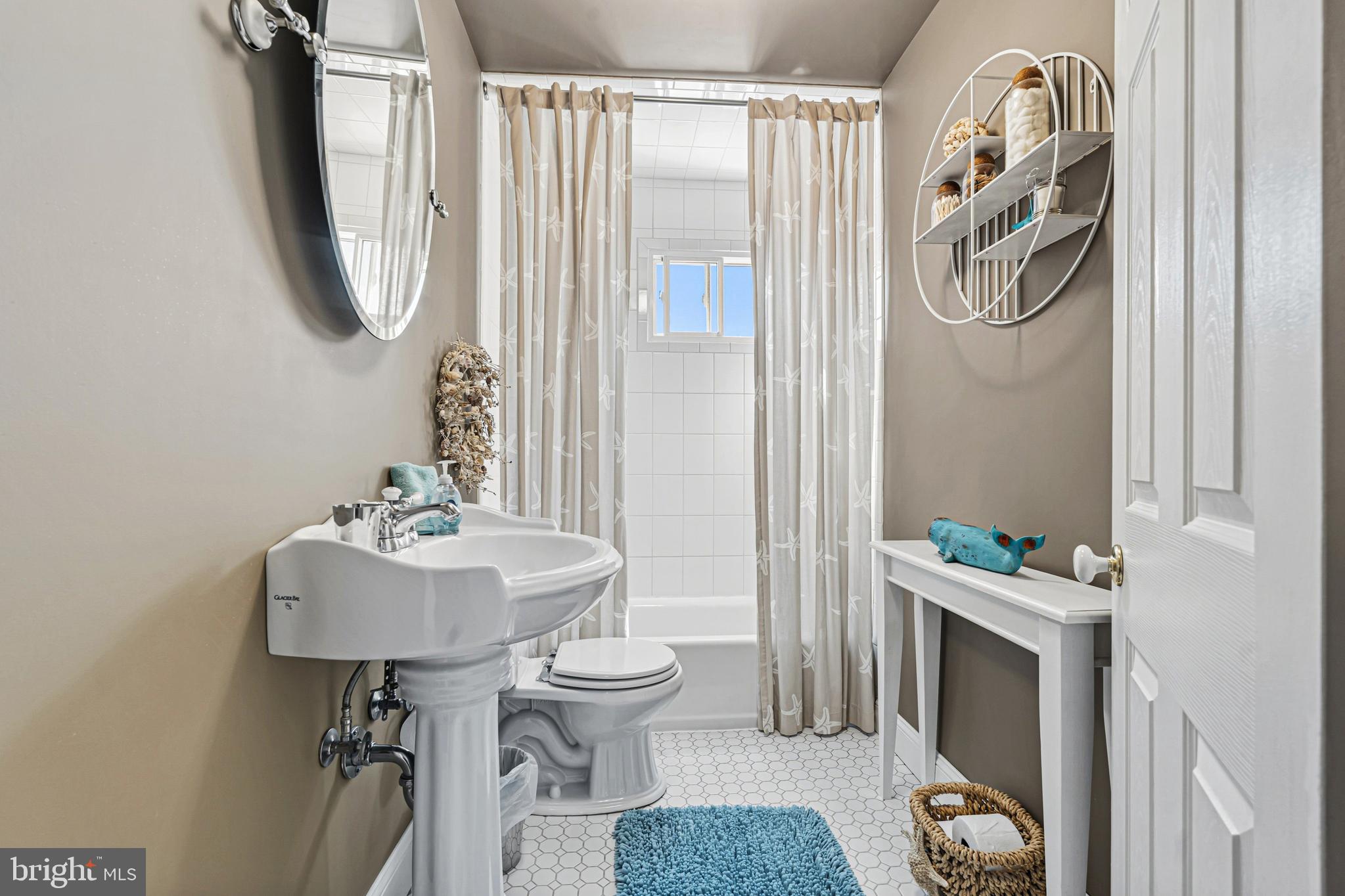7815 Rockbourne Road Baltimore, MD 21222 - Photo 23 of 39 a bathroom with a sink toilet and a mirror