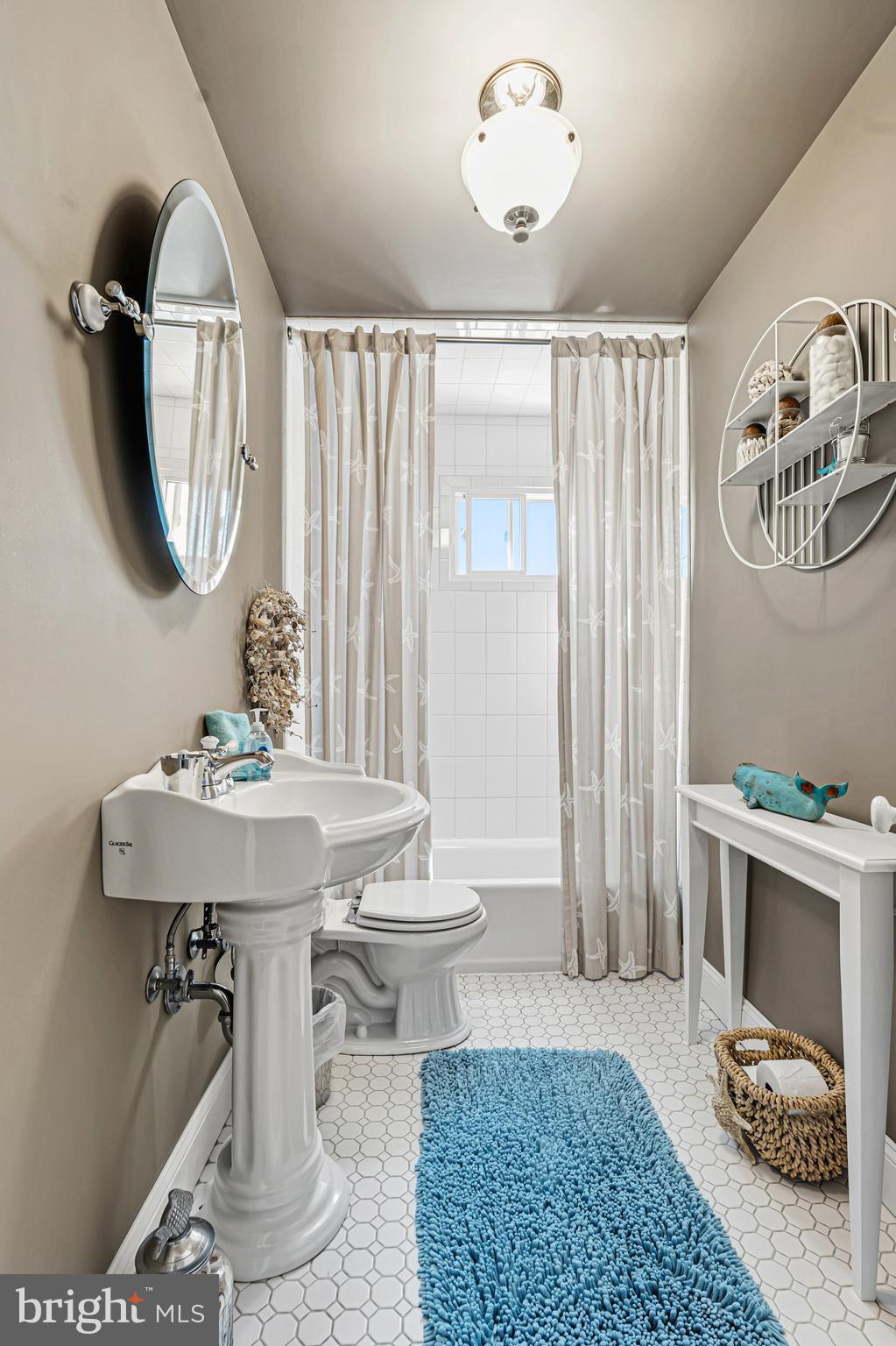 7815 Rockbourne Road Baltimore, MD 21222 - Photo 24 of 39 a bathroom with a sink a mirror and a toilet