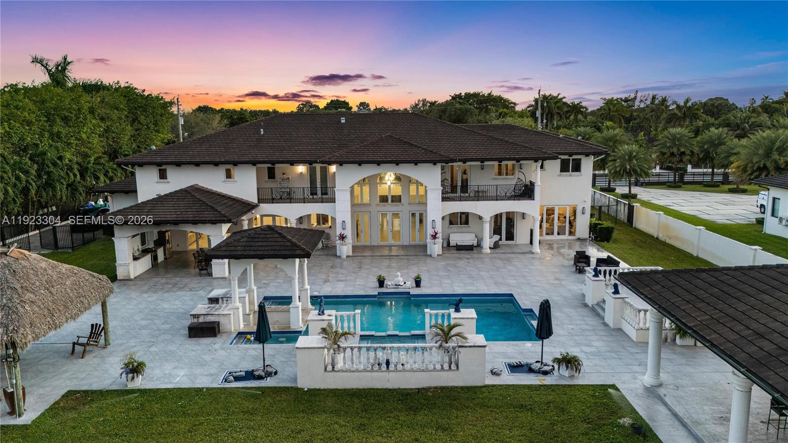 an aerial view of a house with swimming pool garden and patio