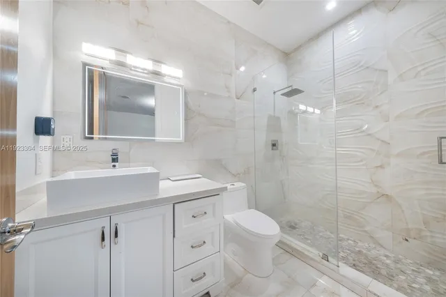 a front view of a house with a yard and lake view