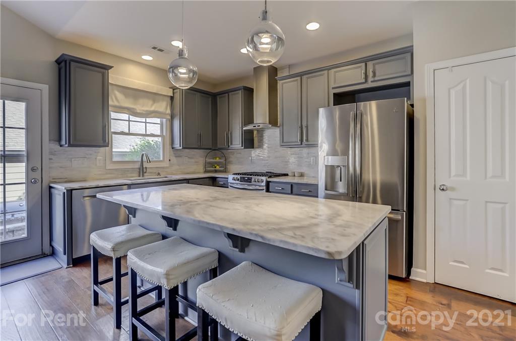 1033 Market Street Fort Mill, SC 29708 - Photo 11 of 46 a kitchen with stainless steel appliances granite countertop a sink refrigerator and cabinets