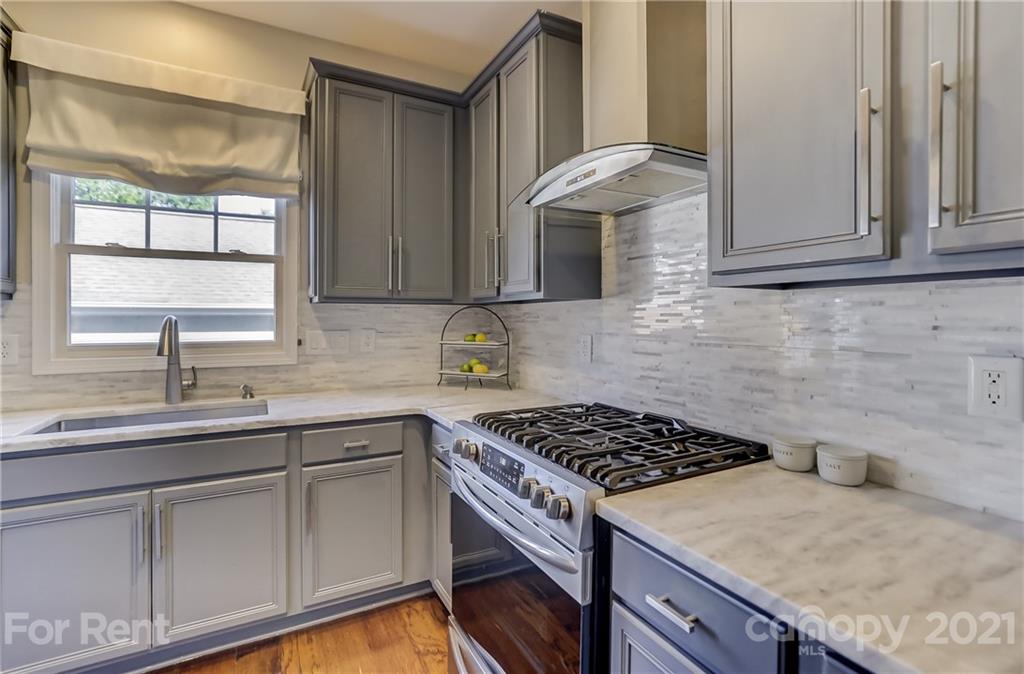 1033 Market Street Fort Mill, SC 29708 - Photo 13 of 46 a kitchen with granite countertop a sink stove and cabinets
