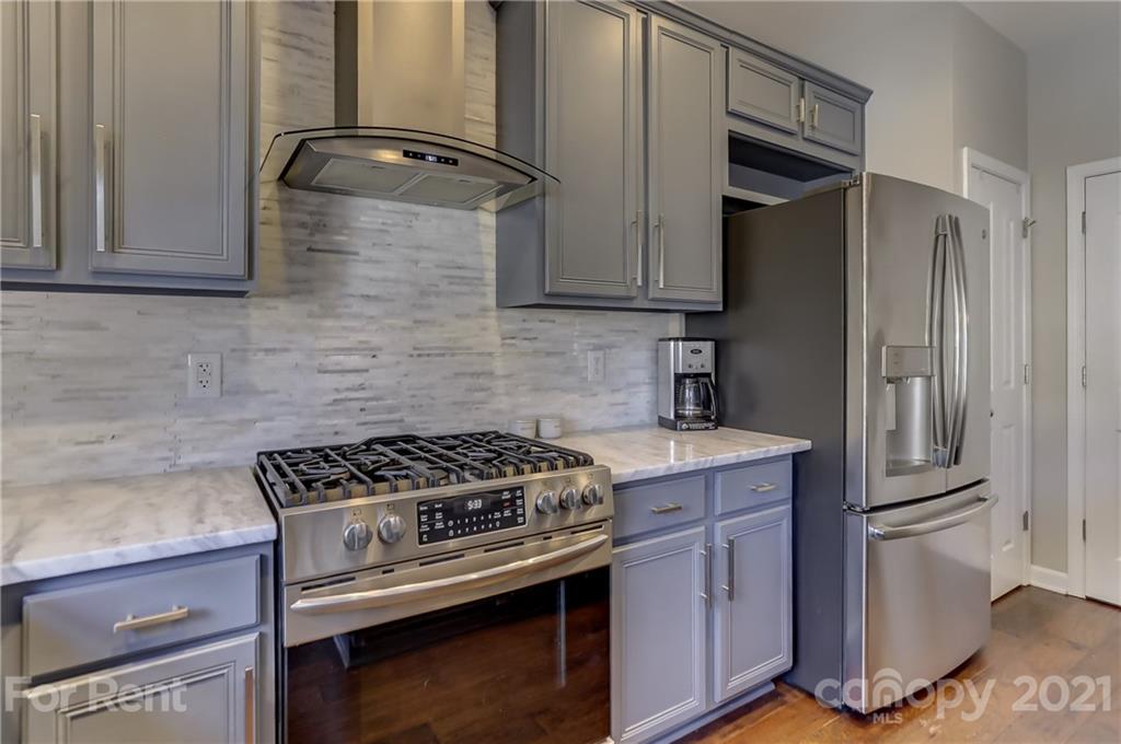 1033 Market Street Fort Mill, SC 29708 - Photo 15 of 46 a kitchen with granite countertop a stove and a refrigerator