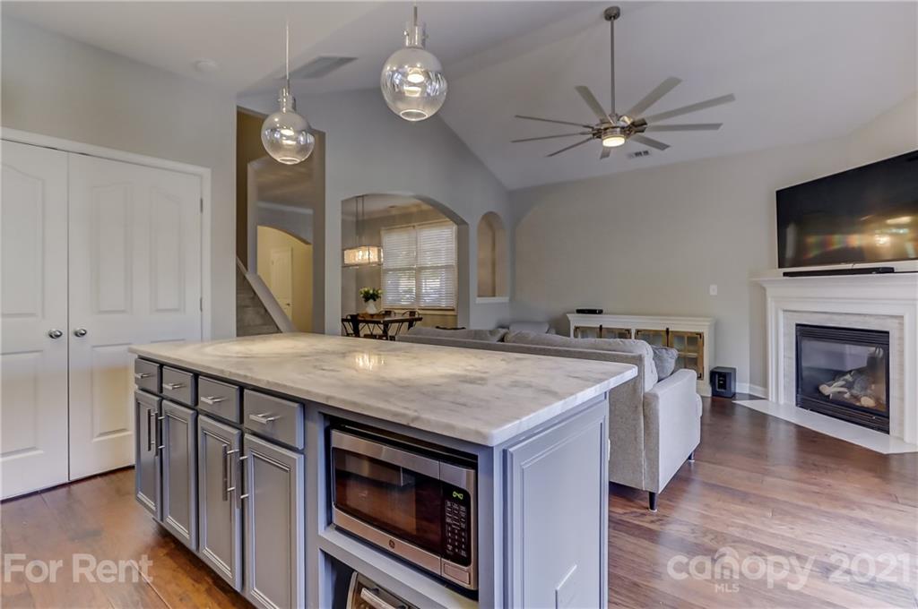 1033 Market Street Fort Mill, SC 29708 - Photo 16 of 46 a kitchen with a stove and a wooden floor