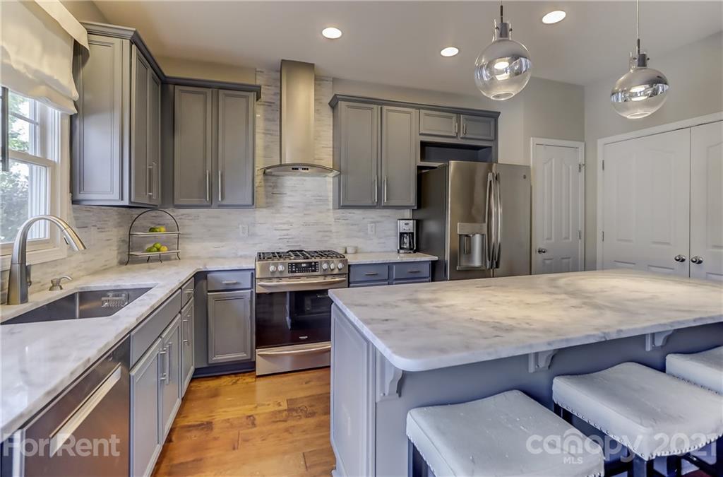 1033 Market Street Fort Mill, SC 29708 - Photo 17 of 46 a kitchen with kitchen island a sink stove and refrigerator