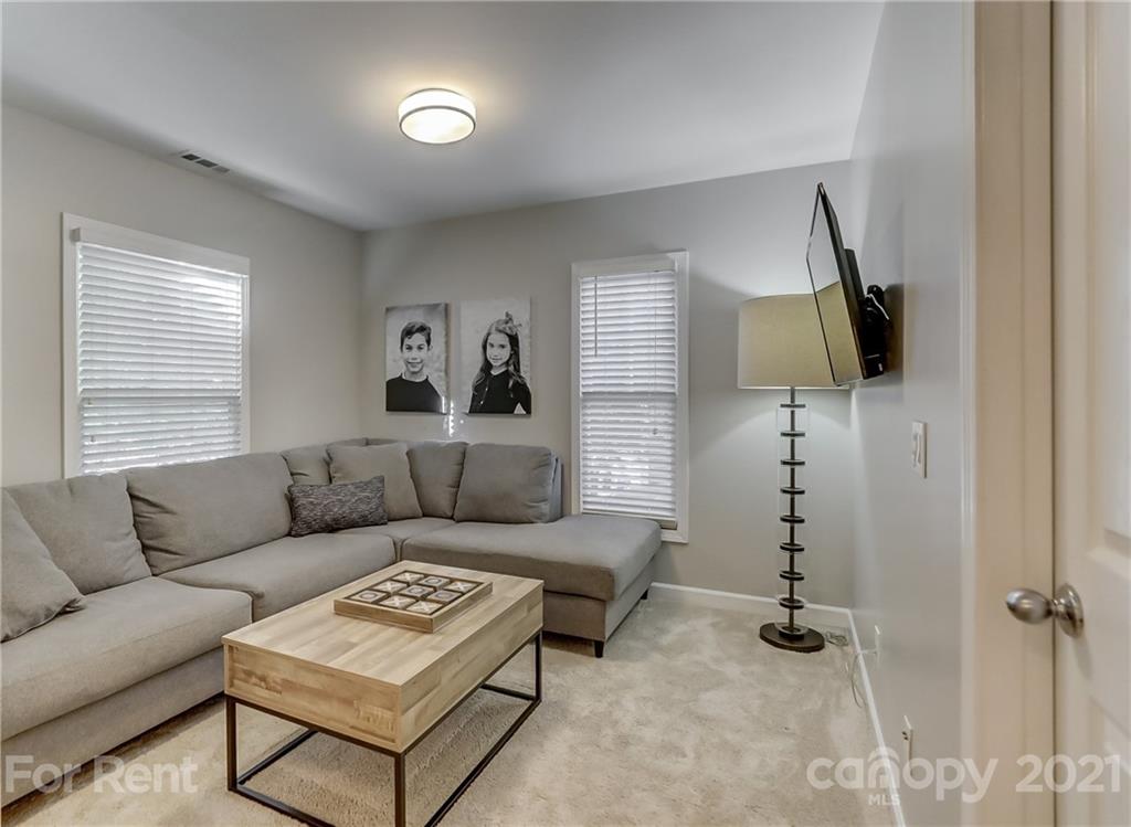 1033 Market Street Fort Mill, SC 29708 - Photo 24 of 46 a living room with furniture and a flat screen tv