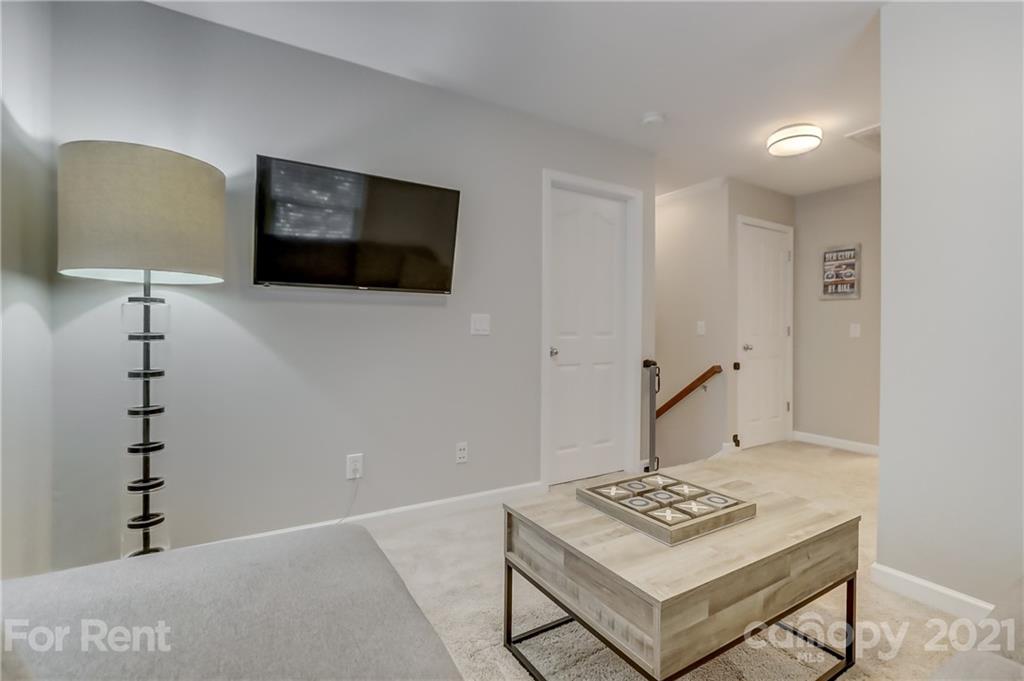 1033 Market Street Fort Mill, SC 29708 - Photo 25 of 46 a living room with couch and a flat screen tv