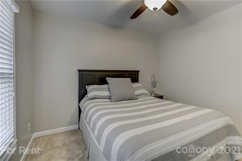 1033 Market Street Fort Mill, SC 29708 - Photo 27 of 46 a bedroom with a bed and painting on the wall