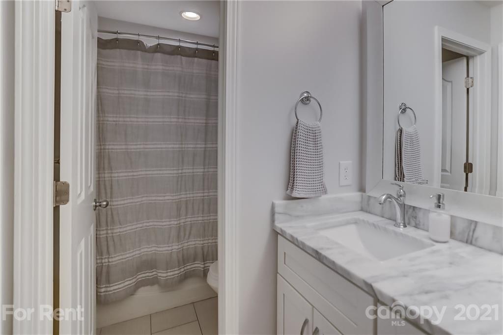 1033 Market Street Fort Mill, SC 29708 - Photo 29 of 46 a bathroom with a granite countertop sink a shower and a mirror