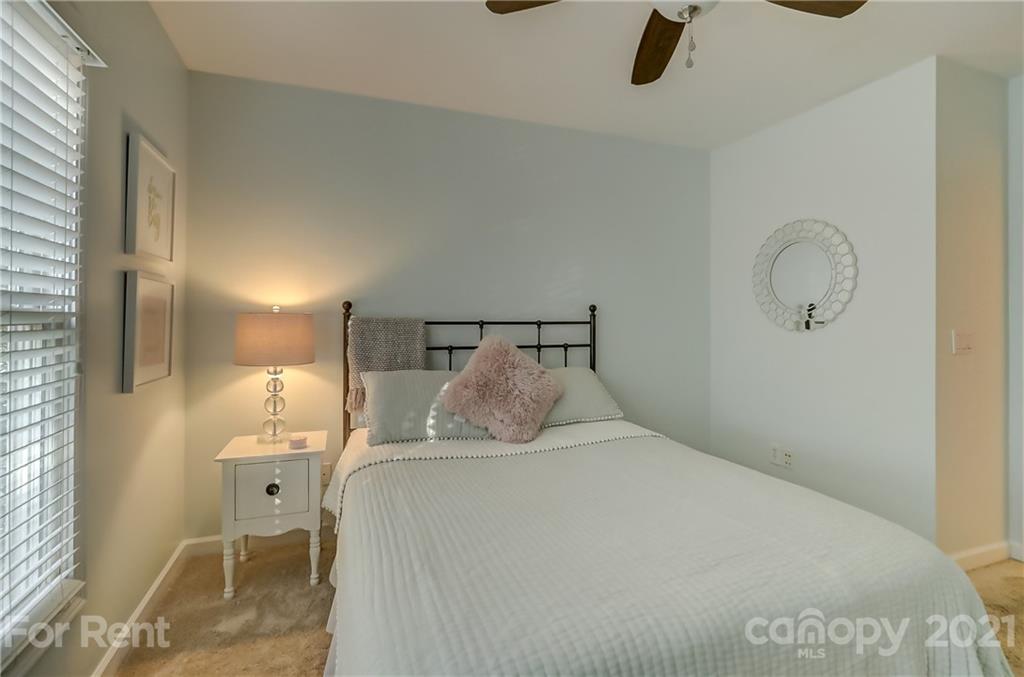1033 Market Street Fort Mill, SC 29708 - Photo 31 of 46 a bedroom with a bed and a chandelier