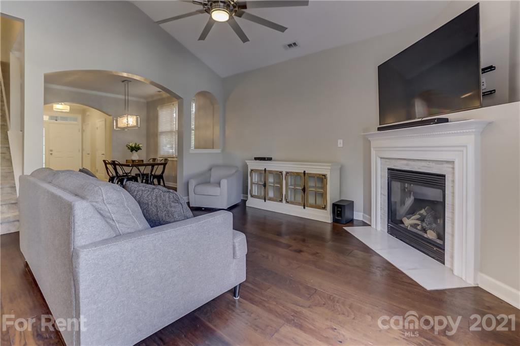 1033 Market Street Fort Mill, SC 29708 - Photo 9 of 46 a living room with furniture a fireplace and a flat screen tv