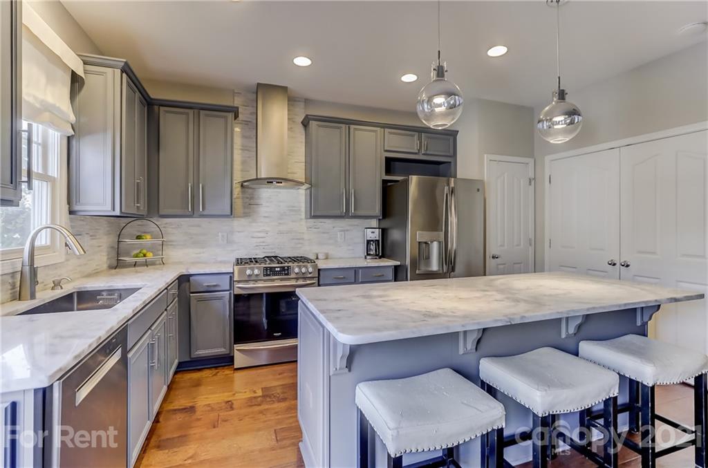 1033 Market Street Fort Mill, SC 29708 - Photo 10 of 46 a kitchen with kitchen island a sink stove and refrigerator