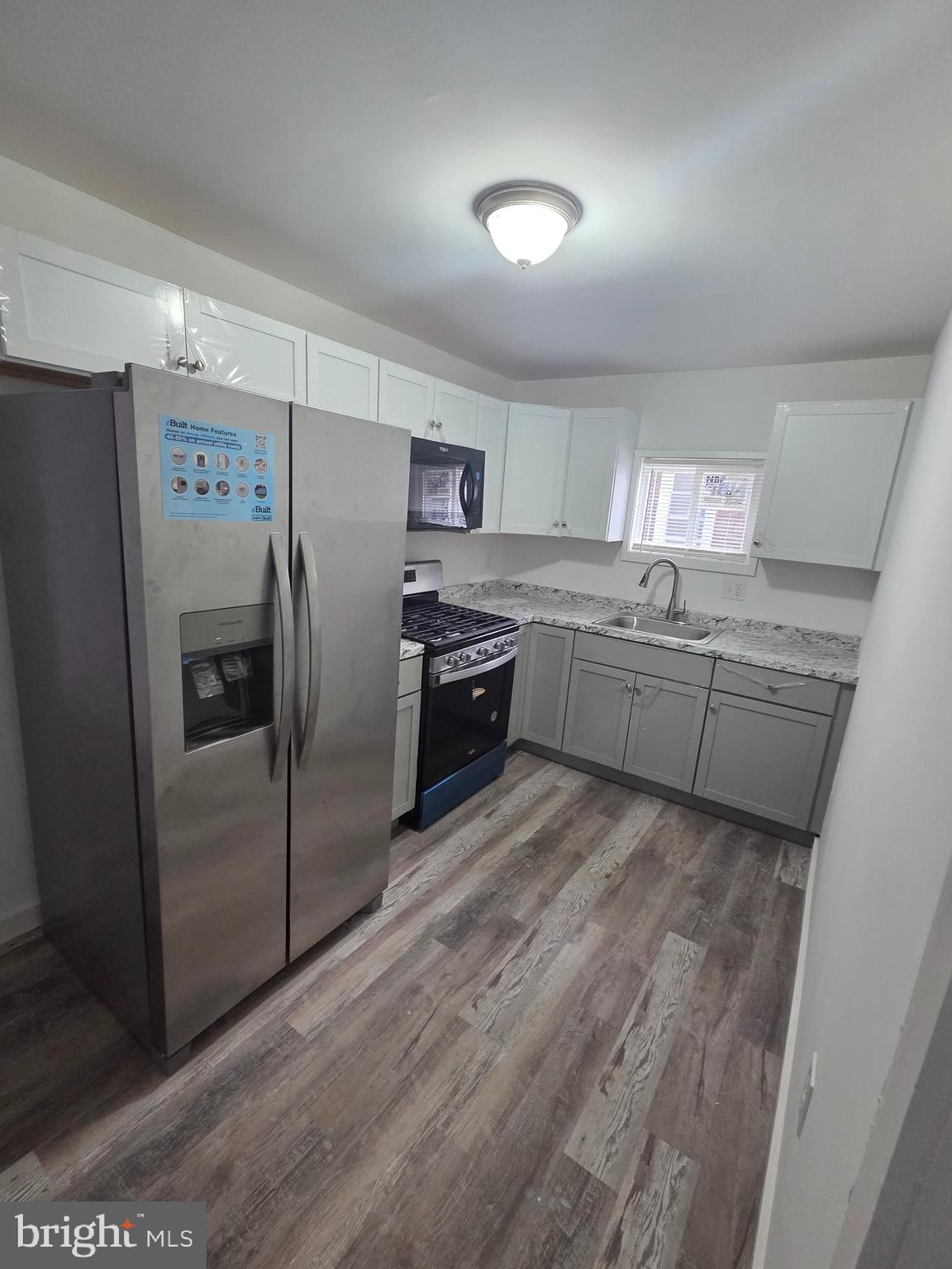6736 Vandike Street Philadelphia, PA 19135 - Photo 11 of 18 a kitchen with stainless steel appliances granite countertop a refrigerator and a stove