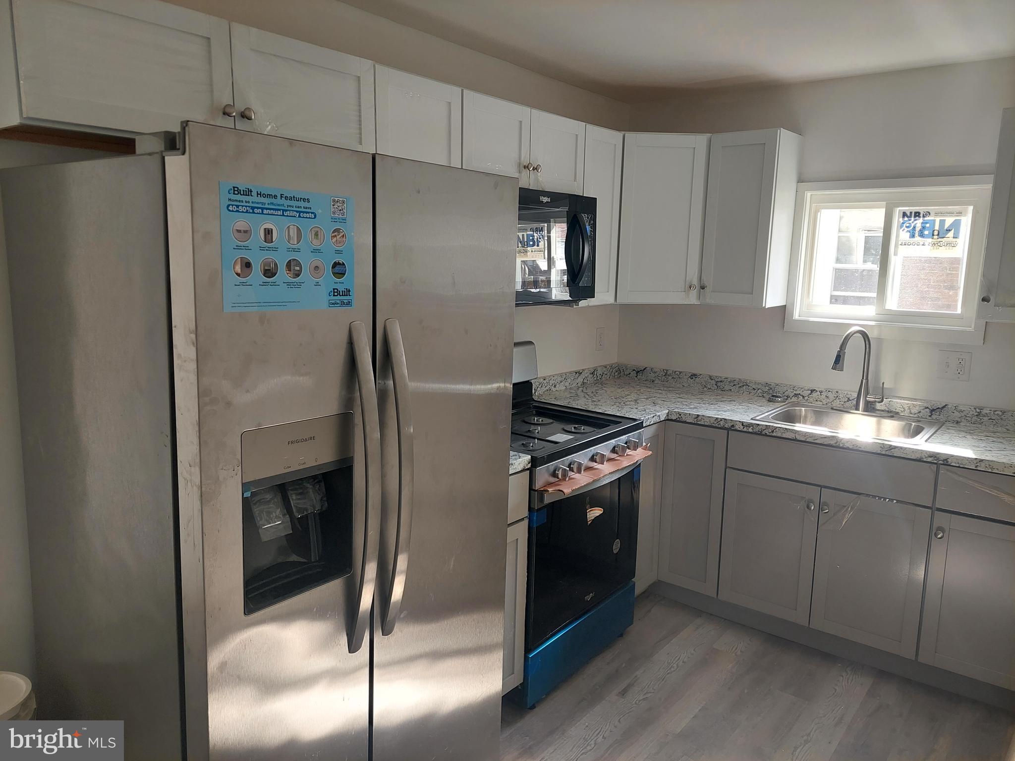 6736 Vandike Street Philadelphia, PA 19135 - Photo 12 of 18 a kitchen with granite countertop a refrigerator and a sink