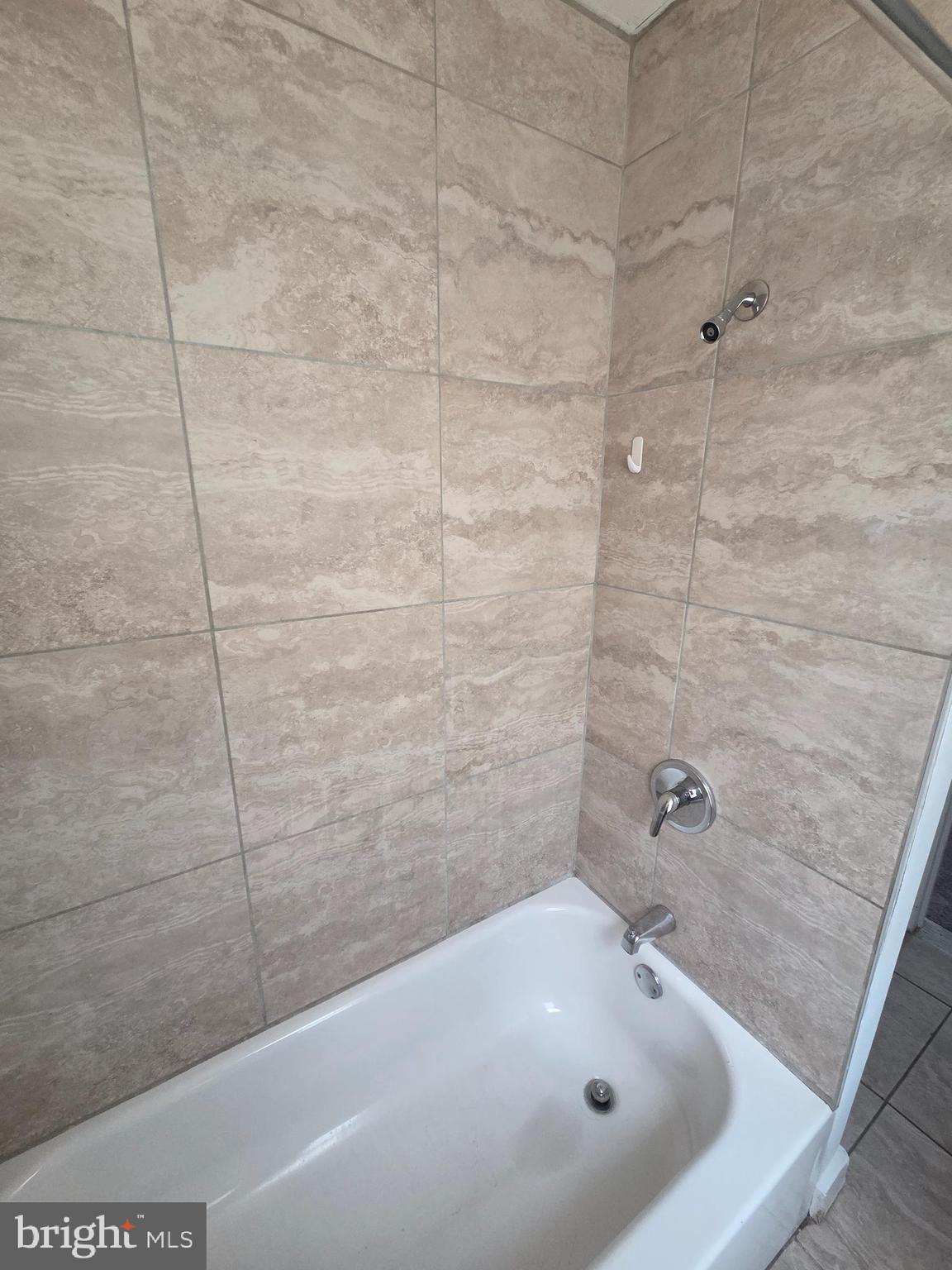 6736 Vandike Street Philadelphia, PA 19135 - Photo 16 of 18 a bathroom with a white bath tub and a shower