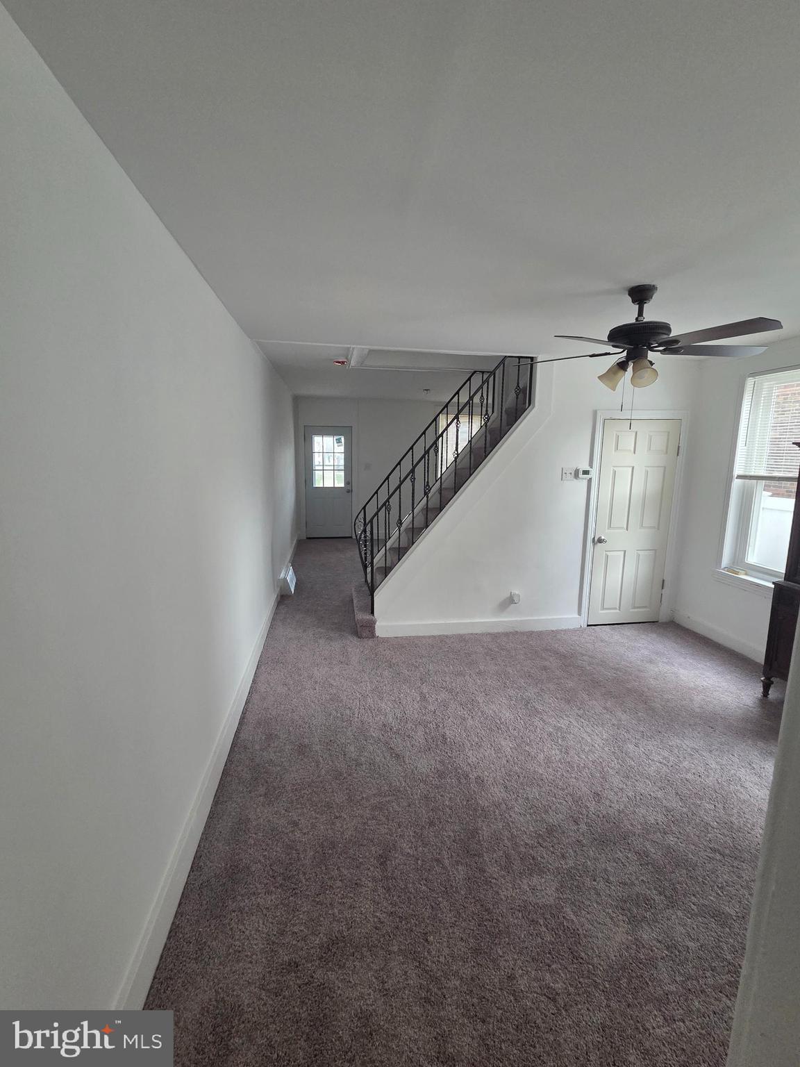 6736 Vandike Street Philadelphia, PA 19135 - Photo 10 of 18 an empty room with windows and stairs