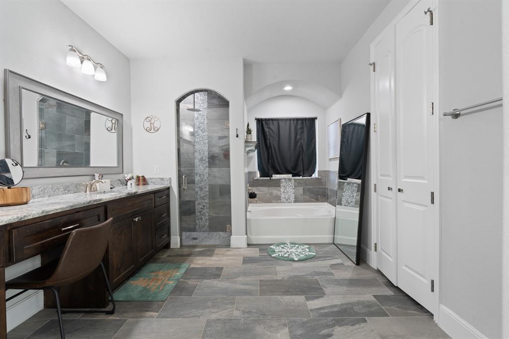 6033 Berry Ridge Lane Joshua, TX 76058 - Photo 16 of 39 a spacious bathroom with a bathtub sink and mirror
