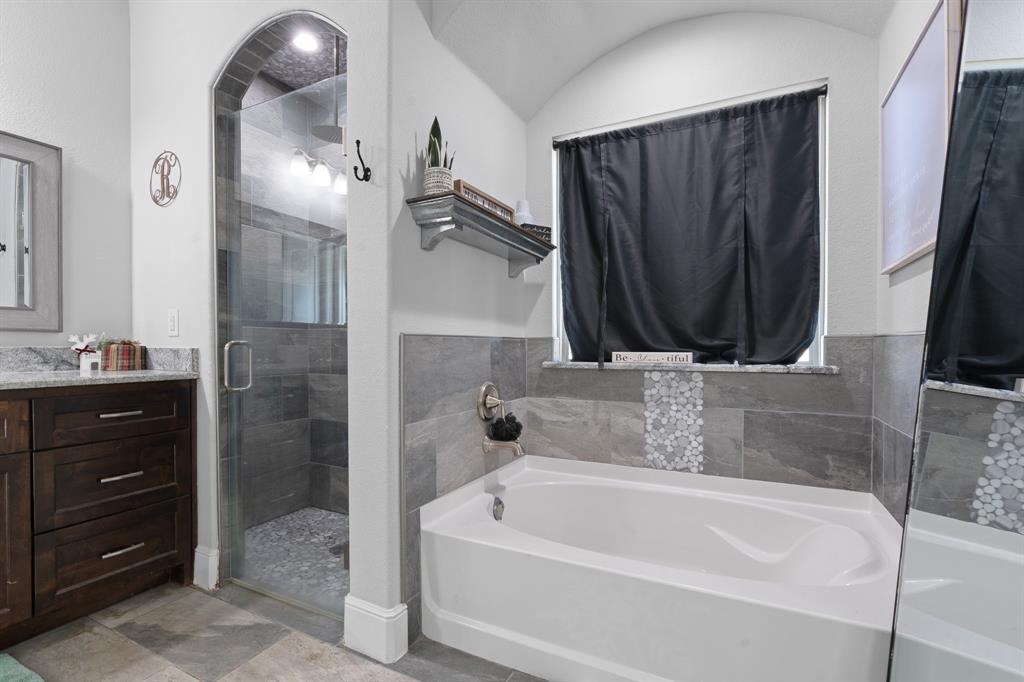 6033 Berry Ridge Lane Joshua, TX 76058 - Photo 17 of 39 a bathroom with a tub a sink and a mirror