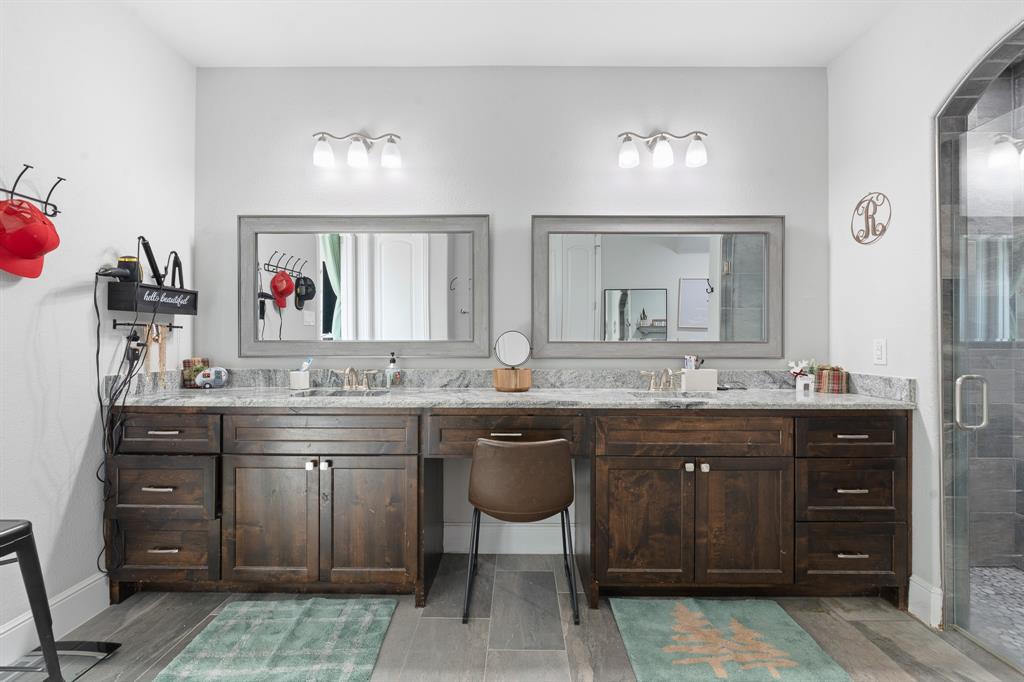 6033 Berry Ridge Lane Joshua, TX 76058 - Photo 18 of 39 a spacious bathroom with a granite countertop sink a large mirror and a