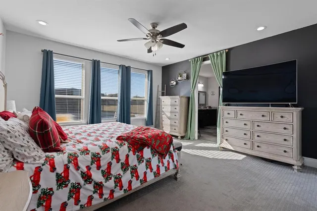 a bedroom with a bed and flat screen tv