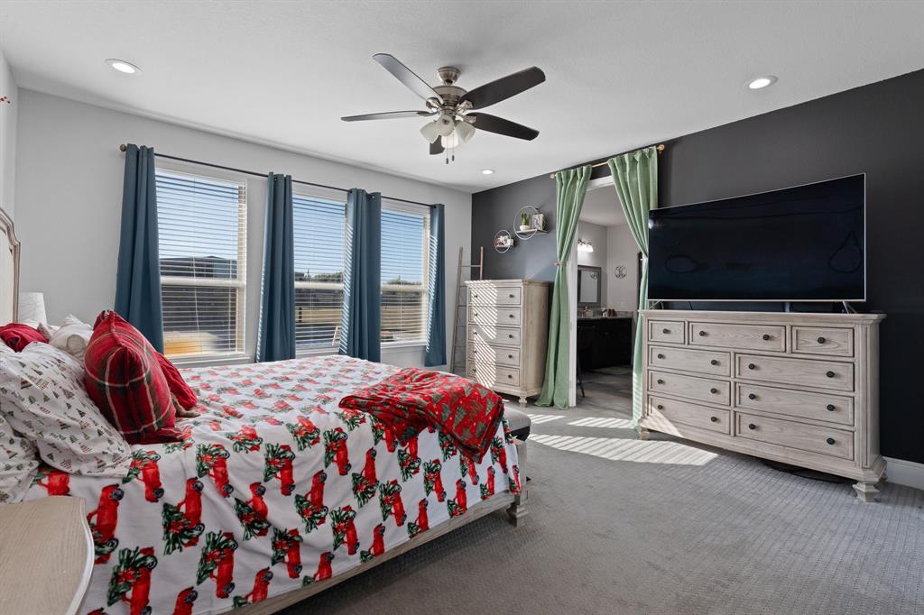 6033 Berry Ridge Lane Joshua, TX 76058 - Photo 21 of 39 a bedroom with a bed and flat screen tv