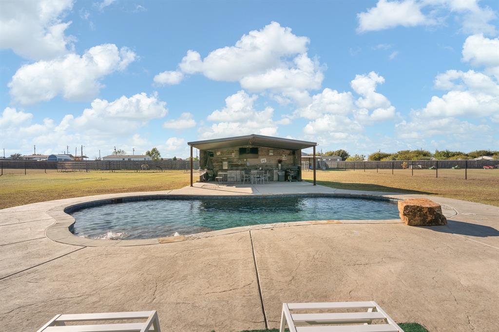 6033 Berry Ridge Lane Joshua, TX 76058 - Photo 27 of 39 a view of swimming pool with outdoor seating and yard in back