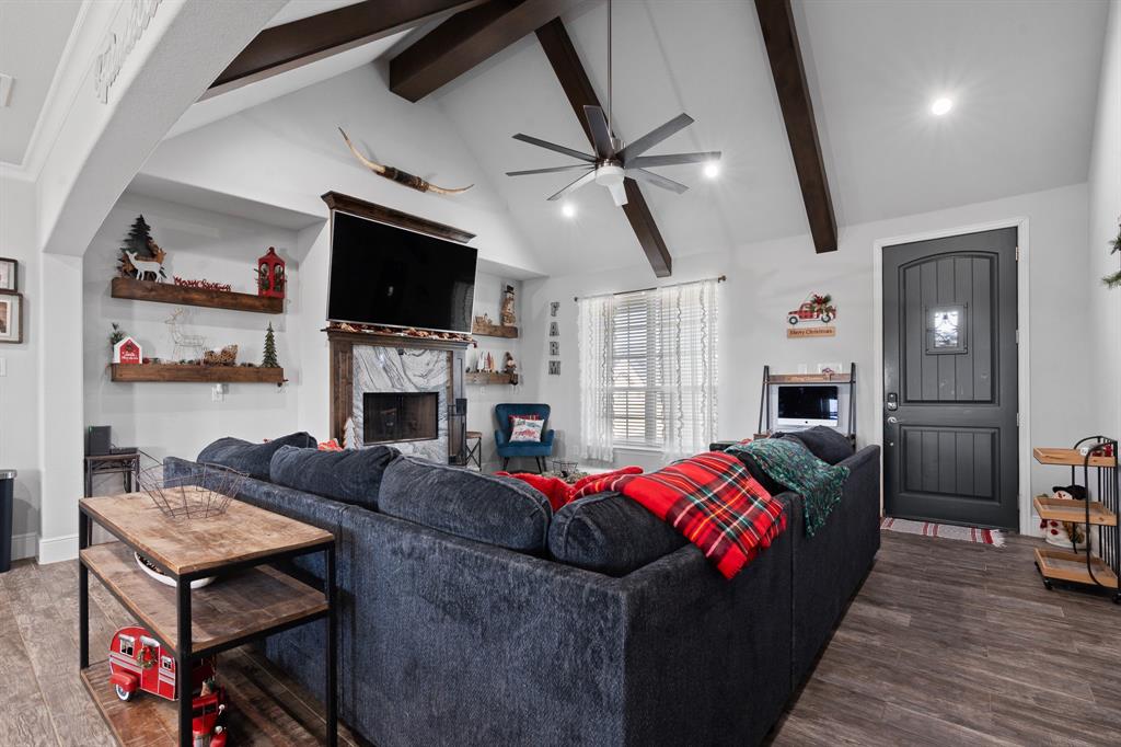 6033 Berry Ridge Lane Joshua, TX 76058 - Photo 5 of 39 a living room with furniture a flat screen tv and a fireplace