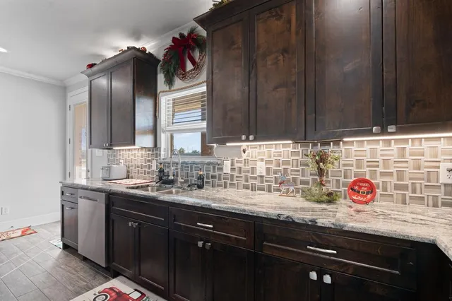 a kitchen with a sink a cabinets and window