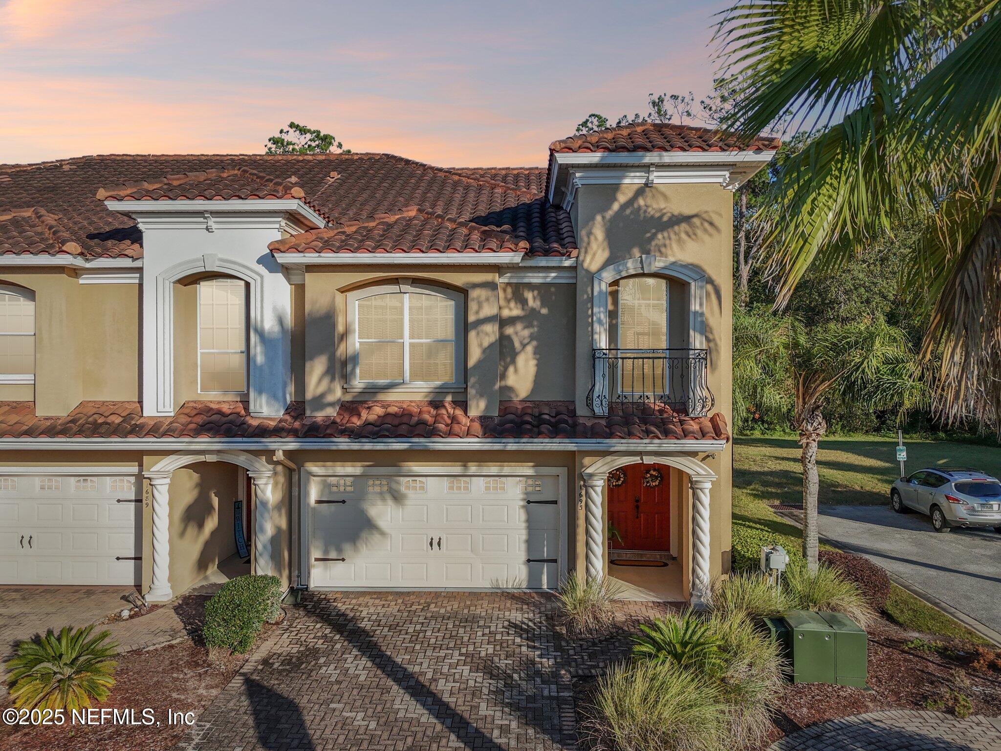 1693 Sanctuary Way Fleming Island, FL 32003 - Photo 1 of 33 a large white building with a clock tower in the middle