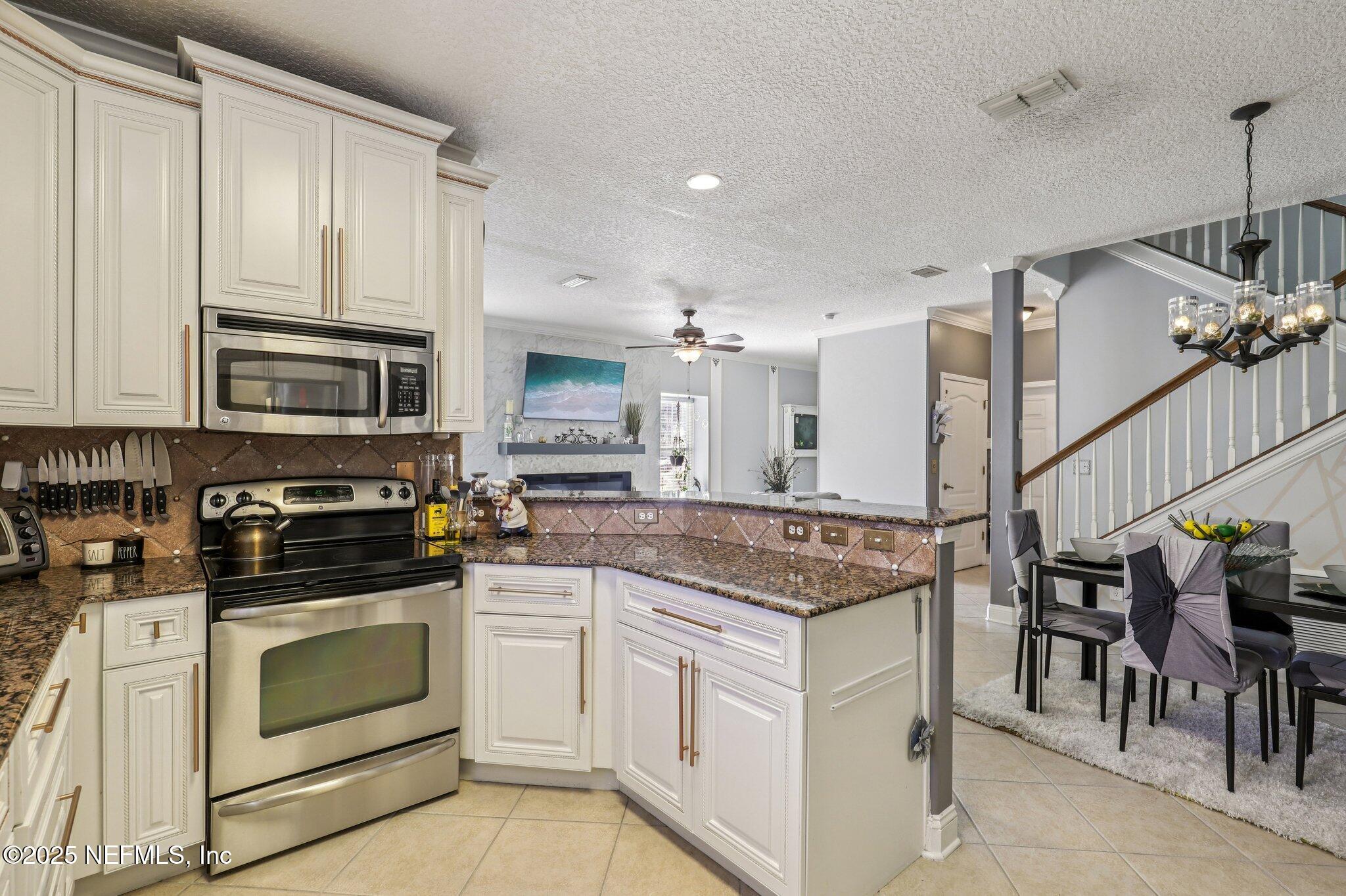 1693 Sanctuary Way Fleming Island, FL 32003 - Photo 11 of 33 a kitchen with appliances cabinets and furniture