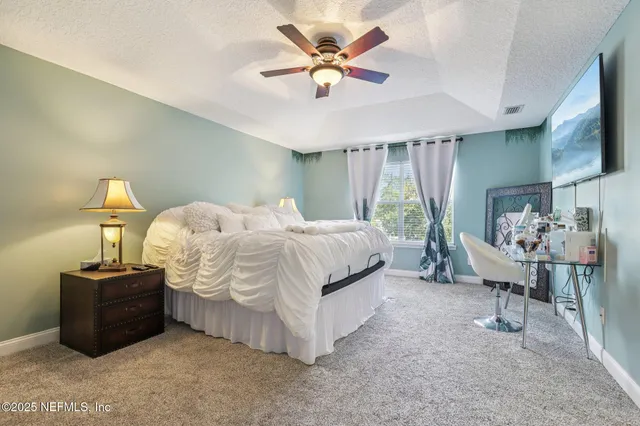 a bathroom with a granite countertop sink a mirror and a shower
