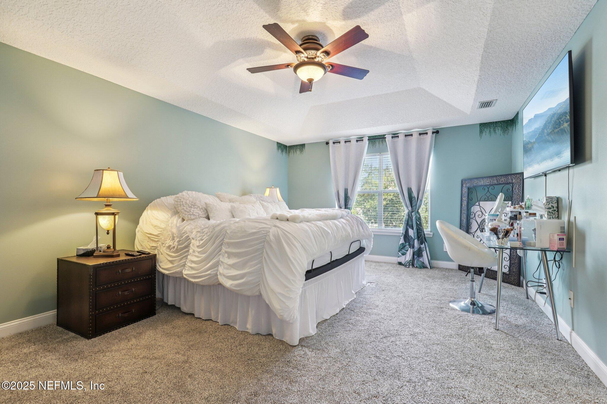 1693 Sanctuary Way Fleming Island, FL 32003 - Photo 16 of 33 a bedroom with bed and window