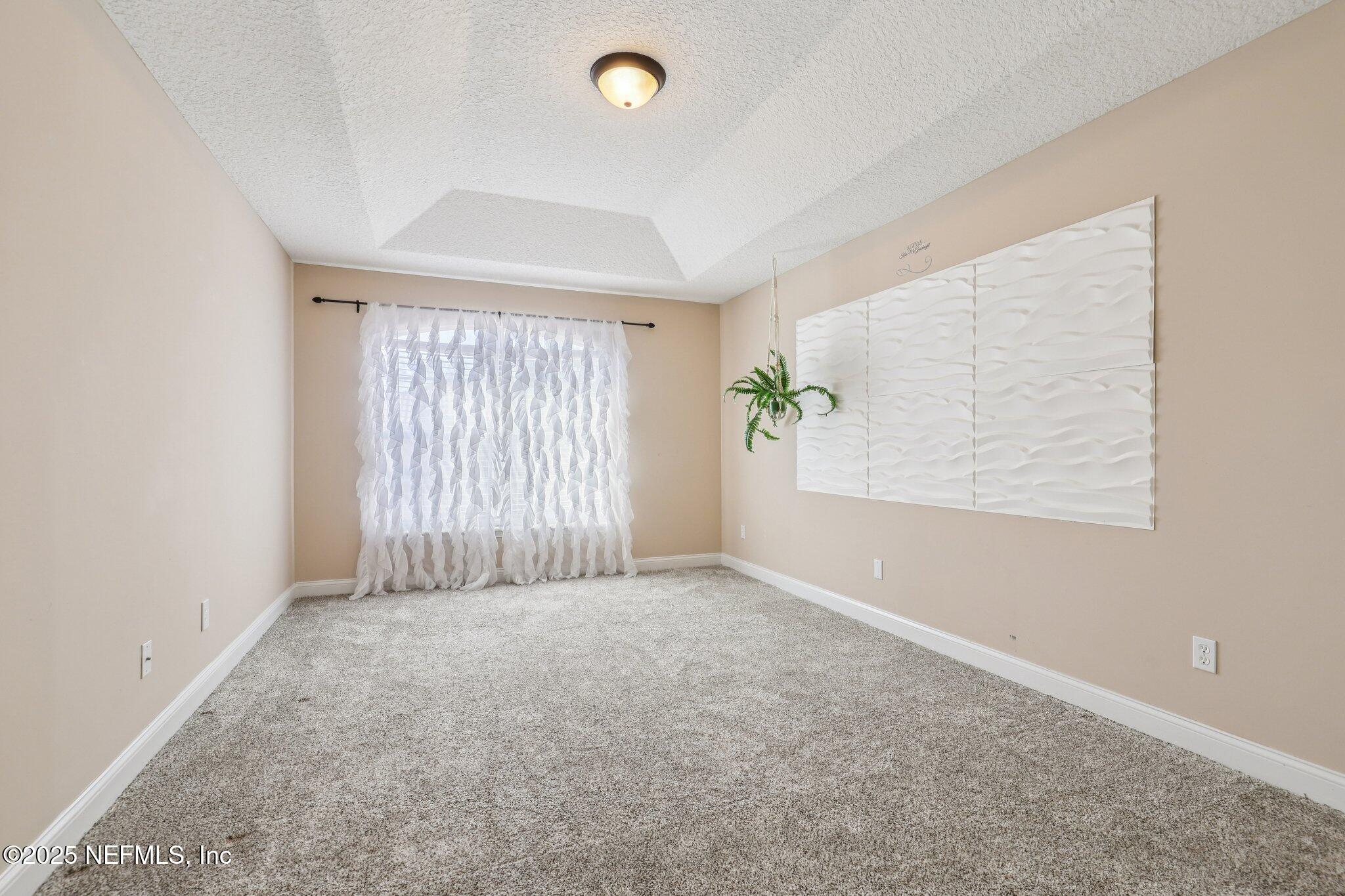 1693 Sanctuary Way Fleming Island, FL 32003 - Photo 22 of 33 an empty room with windows