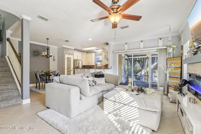 a living room with furniture a flat screen tv and a fireplace
