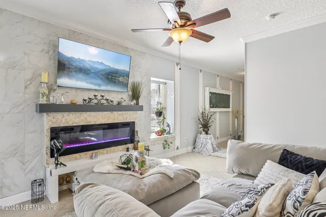 a living room with furniture and a chandelier